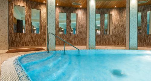 a hot tub in a room with mirrors at Galaxy Hotel in Kraków