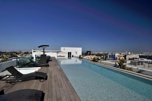a swimming pool on the roof of a building at Kenzi Sidi Maarouf in Casablanca