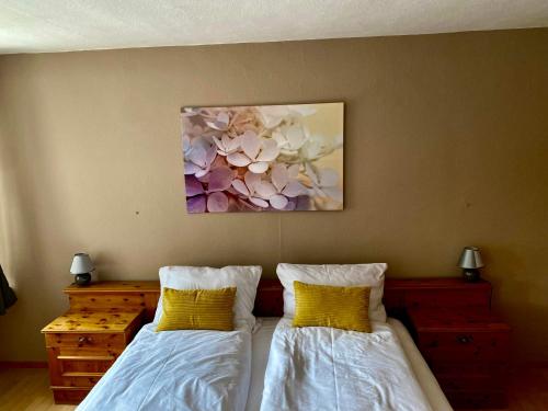 a bedroom with two beds and a painting on the wall at Gasthof Zur Post - Inning in Inning am Ammersee