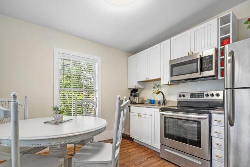 a white kitchen with a table and a refrigerator at Villa Mulvey # 5 in St. Augustine