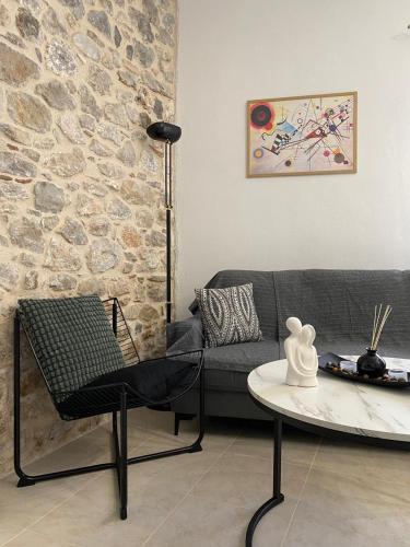 a living room with a couch and a table at Ma Maison Nafplio in Nafplio