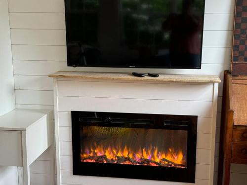 a fireplace with a television on top of it at Acadia Seaside Bungalow in Tremont