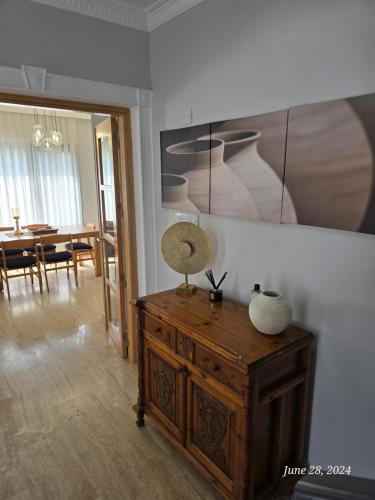 a room with a wooden dresser and a dining room at Villa Mulberry - Kyrenia North Cyprus in Lapithos