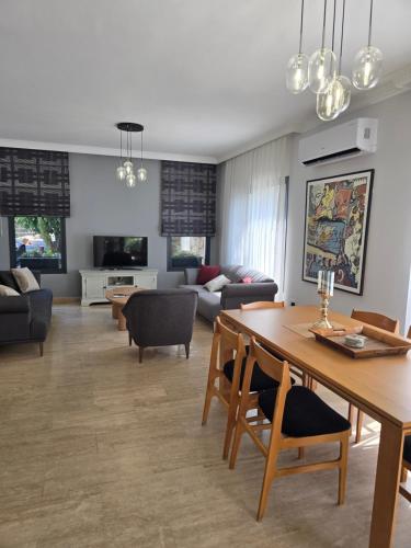 a living room with a table and chairs and a couch at Villa Mulberry - Kyrenia North Cyprus in Lapithos