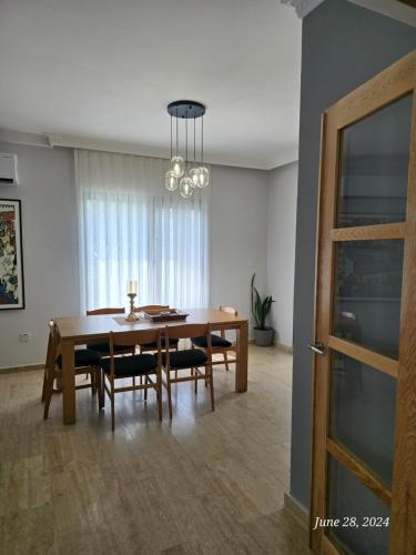a dining room with a wooden table and chairs at Villa Mulberry - Kyrenia North Cyprus in Lapithos