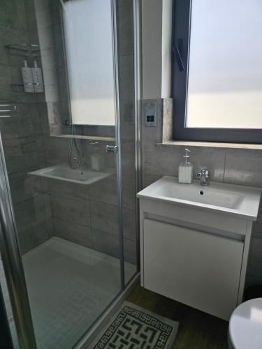 a bathroom with a shower and a sink and a toilet at Villa Mulberry - Kyrenia North Cyprus in Lapithos