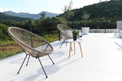 two chairs and a table on a patio at Villa Krivokapic in Trebinje