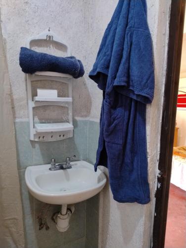 a bathroom with a sink and a blue towel at Rancho Tlalinantli in San Miguel Ajusco