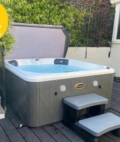 a jacuzzi tub with a toilet sitting in it at The Old Forge in Cheltenham