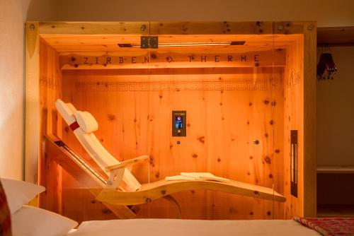 a room with a wooden wall with a treadmill in it at Das Bäckergut am Haldensee in Haldensee