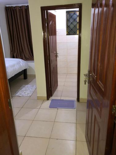 a room with an open door and a tile floor at 3 Bedroom Retreat Apartment In Greatwall Gardens in Athi River