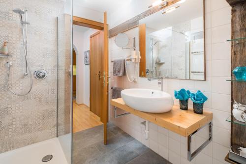a bathroom with a sink and a shower at Das Bäckergut am Haldensee in Haldensee