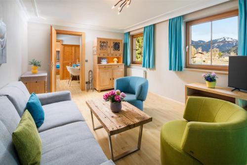 a living room with a couch and two chairs and a table at Das Bäckergut am Haldensee in Haldensee
