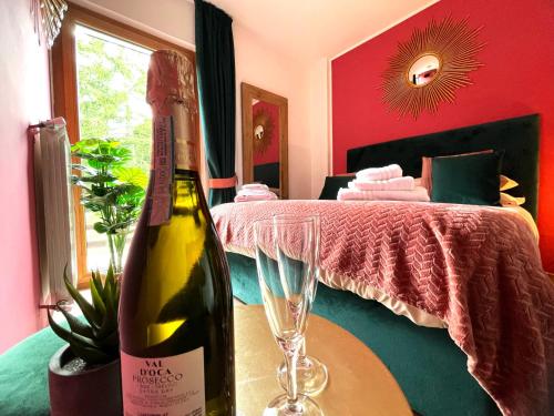 a bottle of wine sitting on a table with a wine glass at Artemide Domus in Pescocostanzo