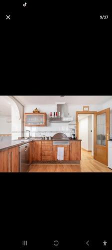 a kitchen with wooden cabinets and a counter top at may in Vihtra