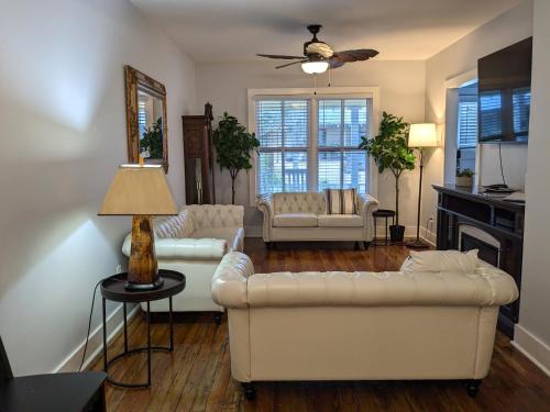 a living room with two white couches and a fireplace at Villa Riberia in St. Augustine