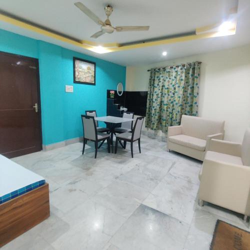 a living room with a table and chairs and a couch at Citynest Homestay in Guwahati