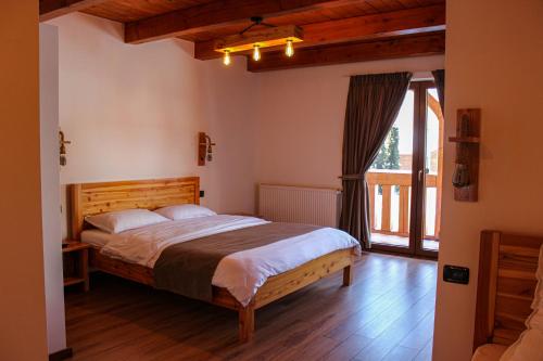 a bedroom with a bed and a large window at CABANA ZIMBRU in Băile Borşa