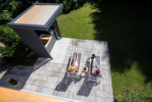 a couple of people laying on a patio at Chalet Ana Bohinj in Bohinj