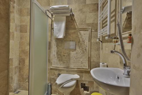 a small bathroom with a sink and a toilet at Relic House in Goreme