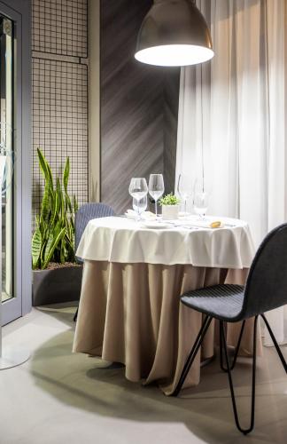 a table with wine glasses on it in a restaurant at Galaxy Hotel in Kraków