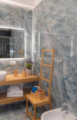 a bathroom with a sink and a mirror at Maison Matie B&B Ercolano in Ercolano