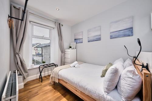 a bedroom with a bed and a window at Princess Green 2 - Portrush by the Sea in Portrush