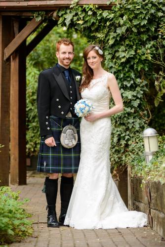 a man in a kilt and a woman in a wedding dress at Waveney House Hotel in Beccles