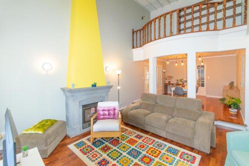 a living room with a couch and a fireplace at Atlantic São Paulo - Nature in the city in Ponta Delgada
