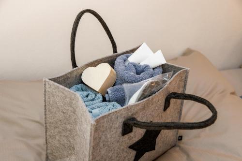 a tote bag filled with towels on a bed at Chalet Ana Bohinj in Bohinj