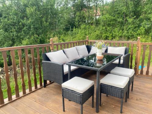 a patio with a table and chairs on a deck at Podkrovní studio apartment pro 1-5 osob in Knínice