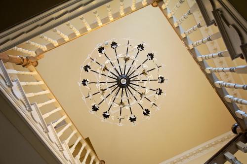 a chandelier hanging from the ceiling of a building at Waveney House Hotel in Beccles