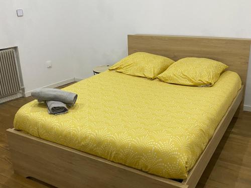 a bed with a phone sitting on top of it at Maison de village spacieuse et calme in Tréveray