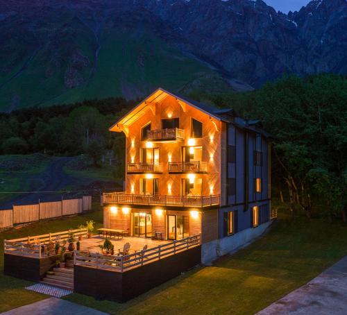 a large building with lights on it at night at 1740 Boutique Hotel Kazbegi in Stepantsminda