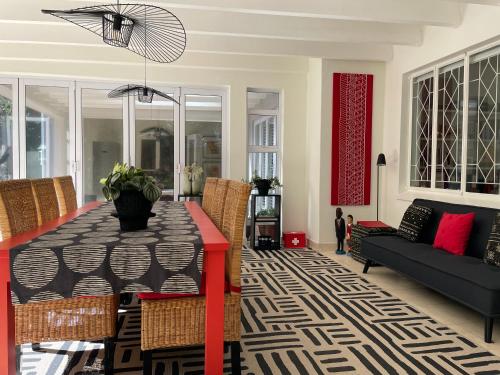a living room with a table and a couch at Home of Synergy in Johannesburg