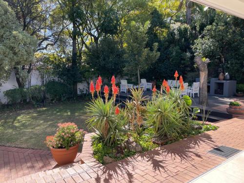 a garden with red flowers in a yard at Home of Synergy in Johannesburg