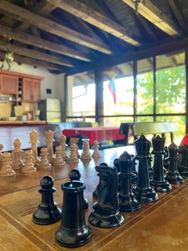 a group of chess pieces on a wooden chessboard at Guest House Debar in Arbanasi