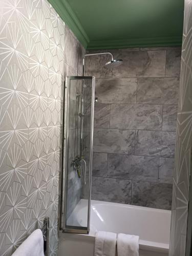 a bathroom with a shower and a bath tub at The Outlook Scarborough in Scarborough