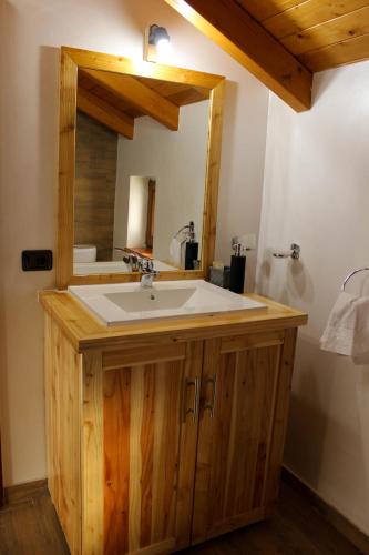 a bathroom with a sink and a mirror at CABANA ZIMBRU in Băile Borşa