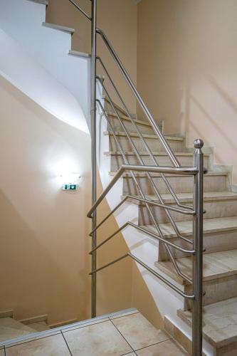 a metal spiral staircase in a room with a tile floor at Faros I in Piraeus