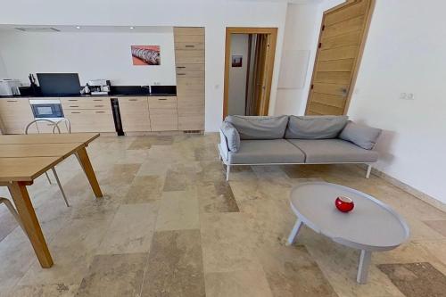 a living room with a couch and a table at ARGIALE - ARGHJALE in Figari