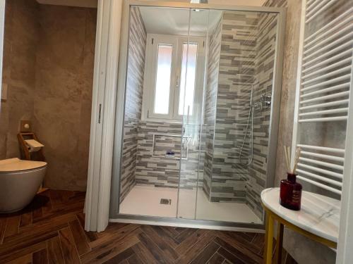 a bathroom with a shower with a glass door at Casa Del Caval Bianco in Venaria Reale