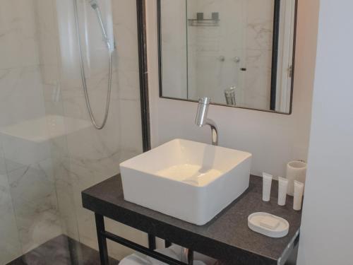a bathroom with a white sink and a shower at Boutique Hotel Castelinho in Rio de Janeiro