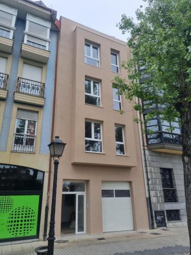 a building with a street light in front of it at ASTURES Viviendas Turísticas in Oviedo
