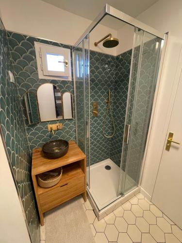 a small bathroom with a shower and a sink at Best view sea Deauville in Deauville