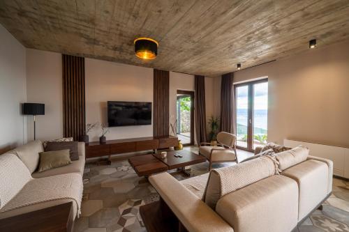 a large living room with couches and a tv at Vila Marigold in Opatija