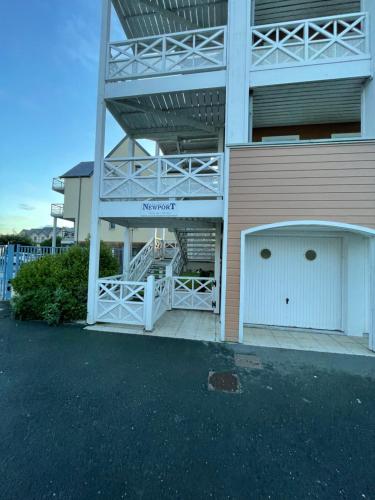 a building with a white gate and a garage at Best view sea Deauville in Deauville