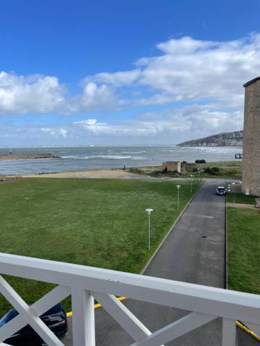 a view of the beach from the balcony of a house at Best view sea Deauville in Deauville