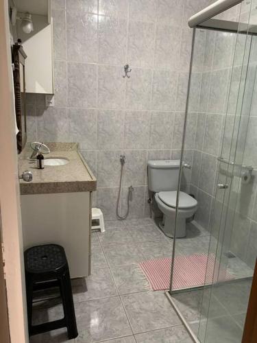 a bathroom with a toilet and a glass shower at Casa Carmo in Ouro Preto