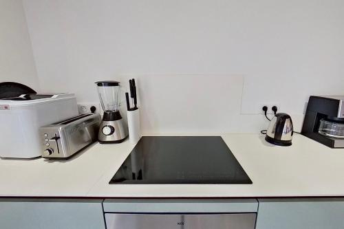 a kitchen counter with a sink and a blender at ARGIALE - ARGHJALE in Figari